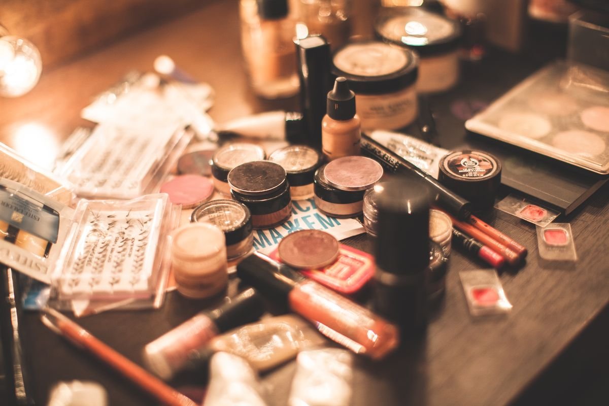 Makeup and cosmetics arranged on a vanity table