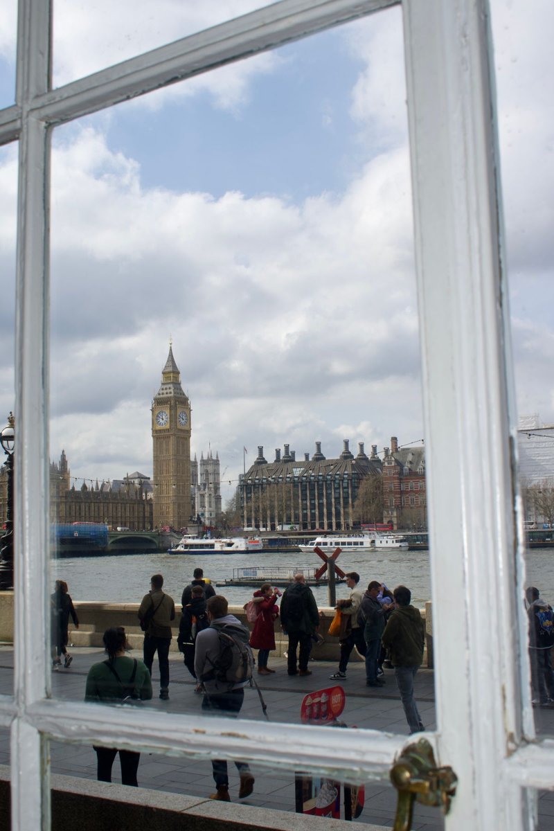 Big Ben and the Thames, seen through an architectural opening in London